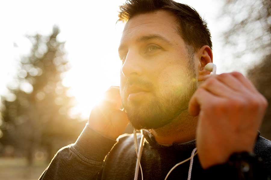 young-man-putting-earphones-outdoors-counselling-vancouver1